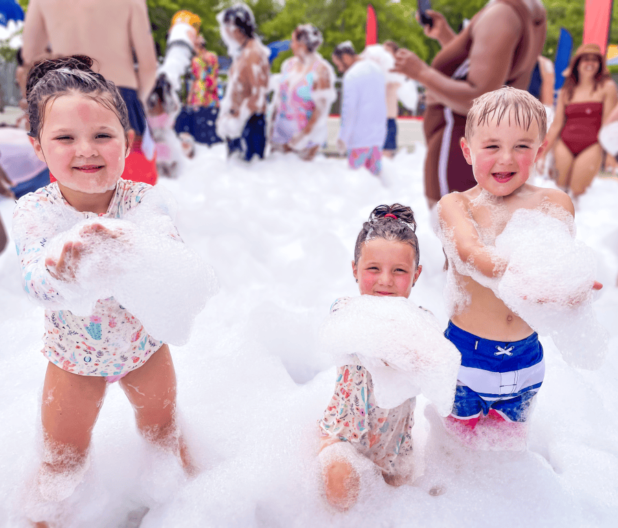 Children play in piles of foam bubbles at Wet ‘n Wild Emerald Pointe.